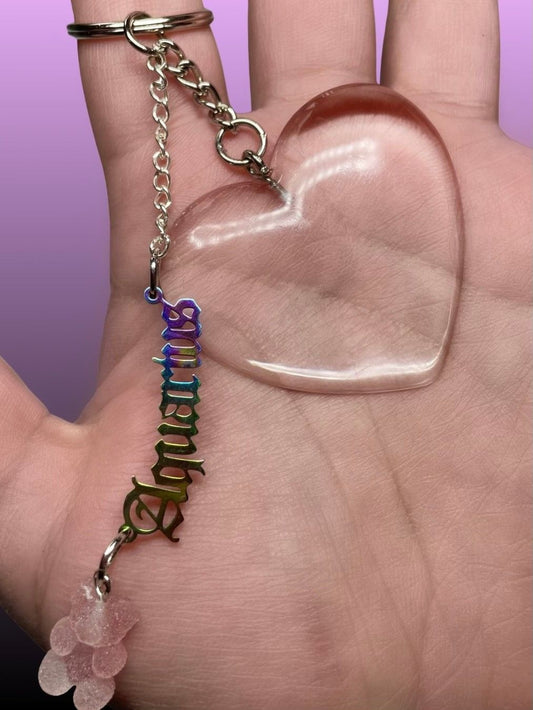 Astrology plate hanging from a resin heart keychain paired with a sugar gummy bear. 